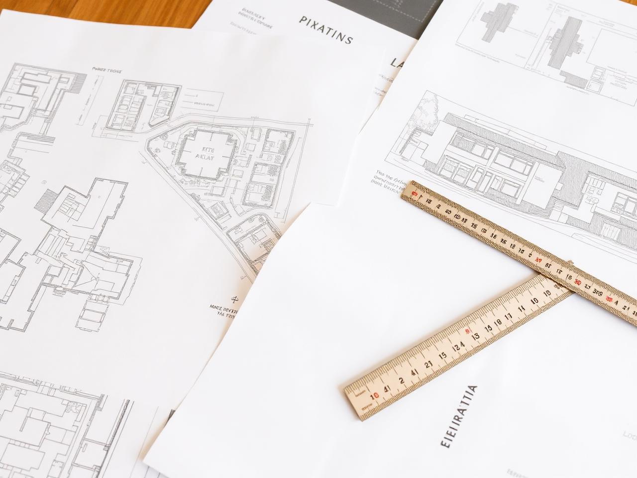 Planning application drawings and scale ruler on a desk